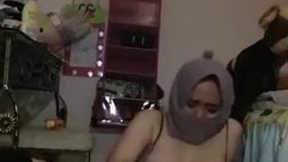 Hot girl in a hijab plays with her toy